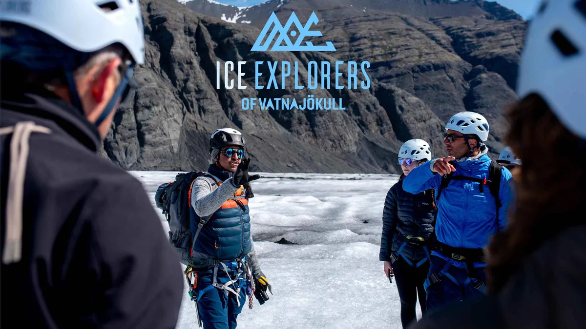 Hikers in crampons crossing blue ice on a Vatnajökull glacier hiking tour from Jökulsárlón, Iceland